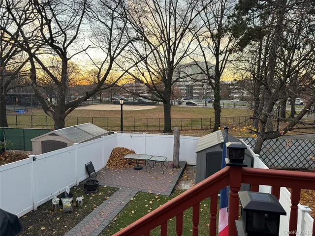 a view of a wooden deck and a backyard