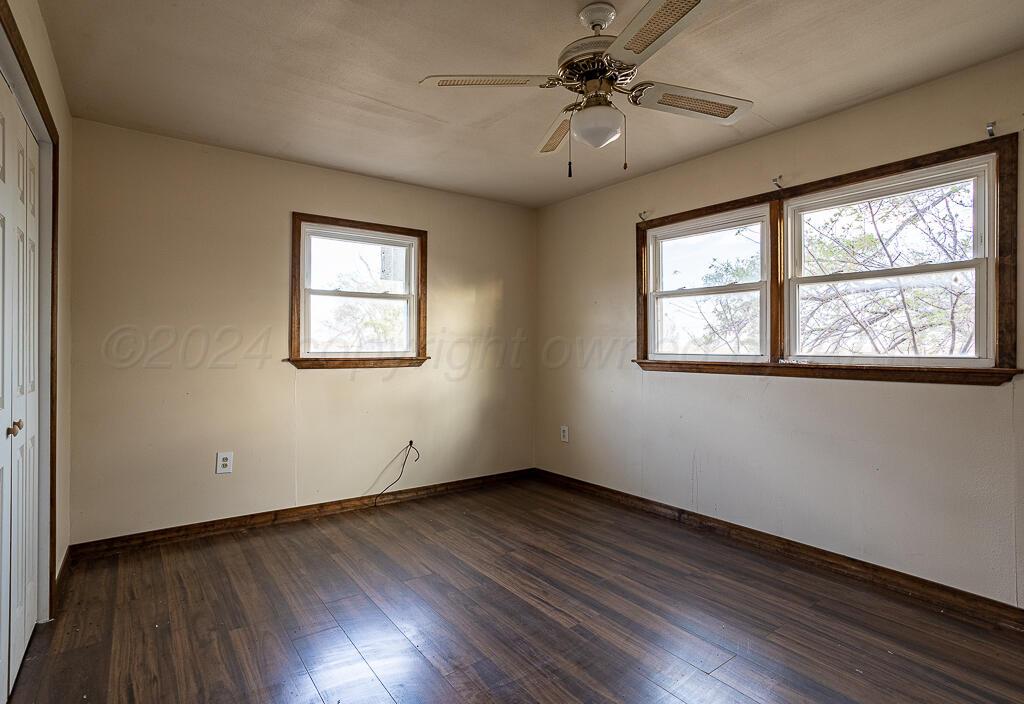 6761 County Road 11 Shamrock, TX 79079 - Photo 11 of 33 a view of an empty room with wooden floor and a window