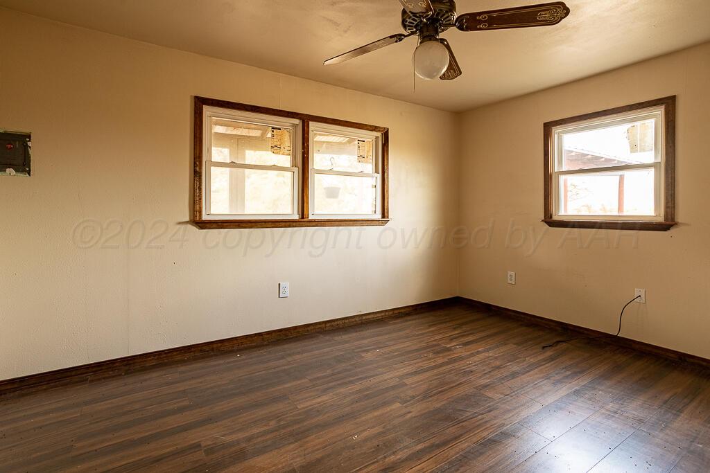 6761 County Road 11 Shamrock, TX 79079 - Photo 13 of 33 a view of an empty room with wooden floor and window