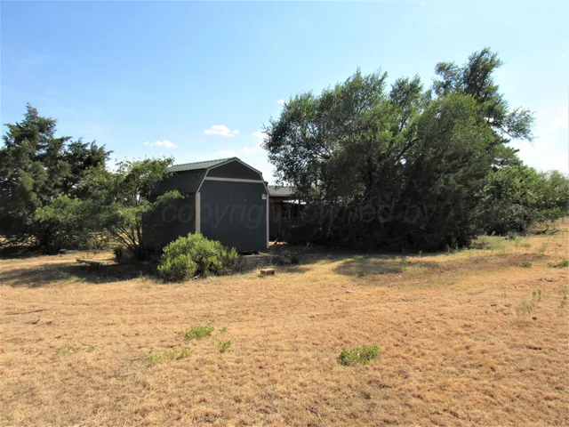 a view of a house with a yard and covered with snow
