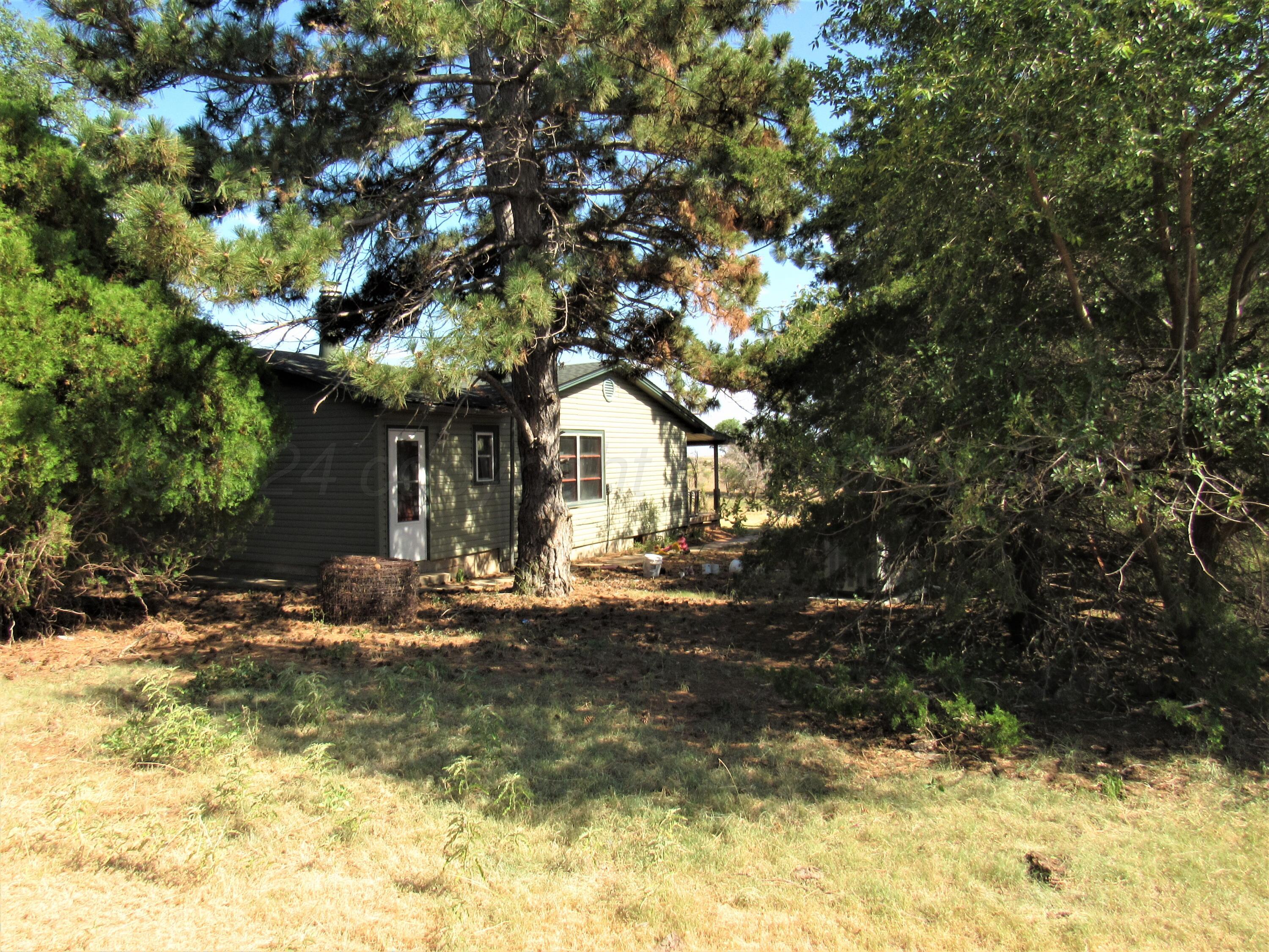 6761 County Road 11 Shamrock, TX 79079 - Photo 23 of 33 a view of a house with a tree in a yard