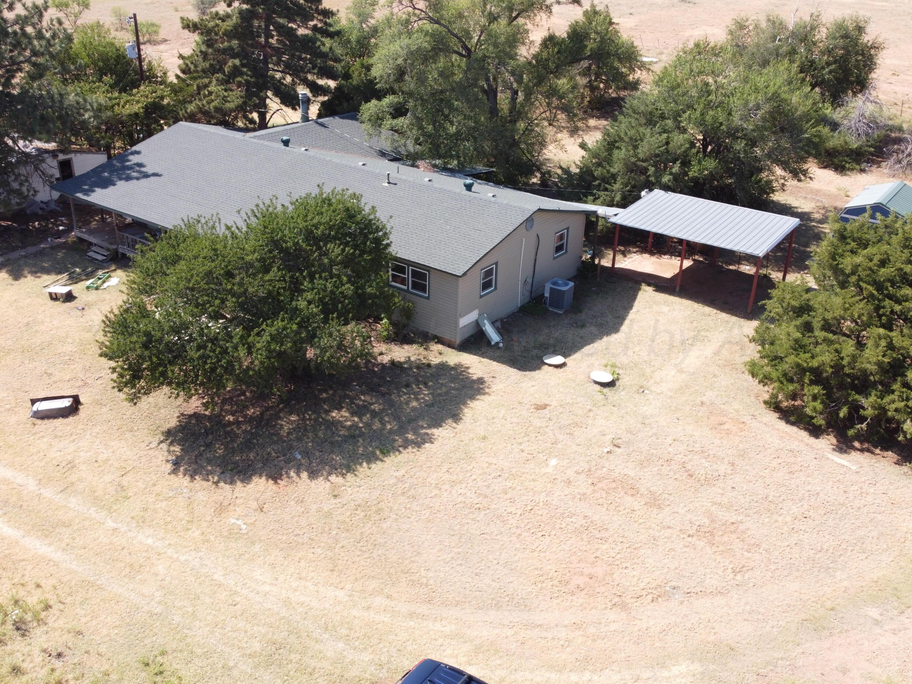 6761 County Road 11 Shamrock, TX 79079 - Photo 28 of 33 an aerial view of house with yard and trees in the background