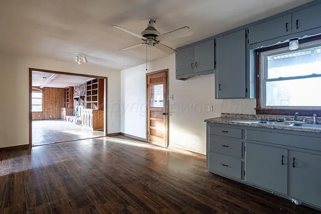 a kitchen with granite countertop cabinets appliances and a window
