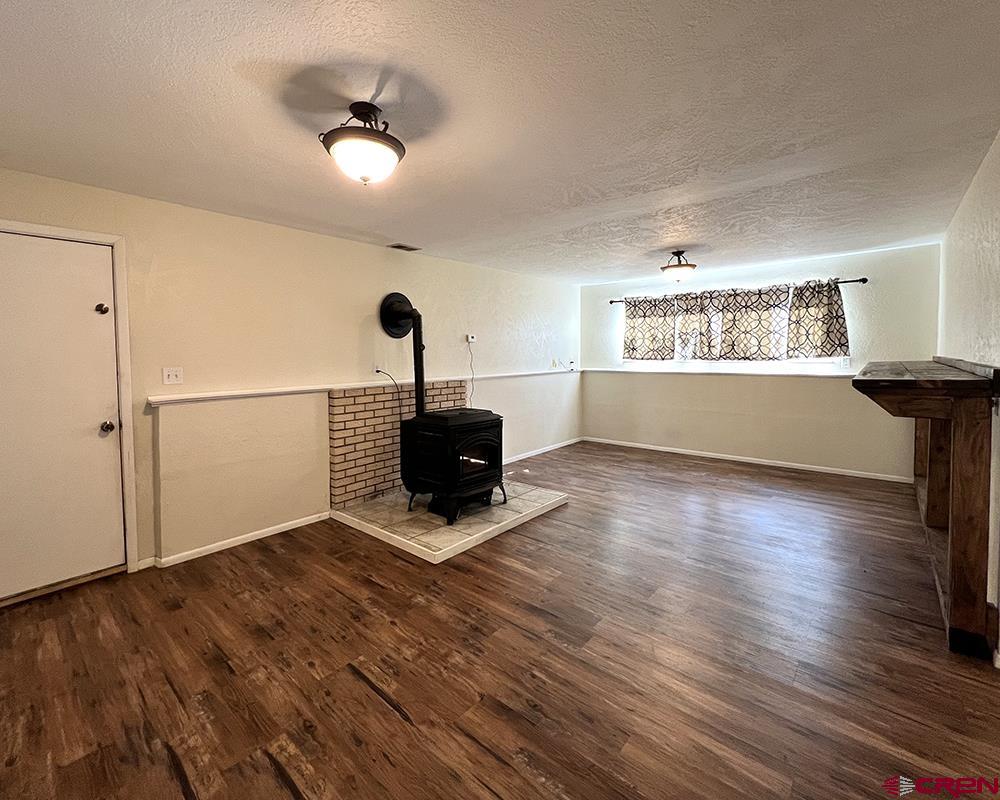 1328 Jackson Street Cortez, CO 81321 - Photo 12 of 45 a view of empty room with wooden floor and fan