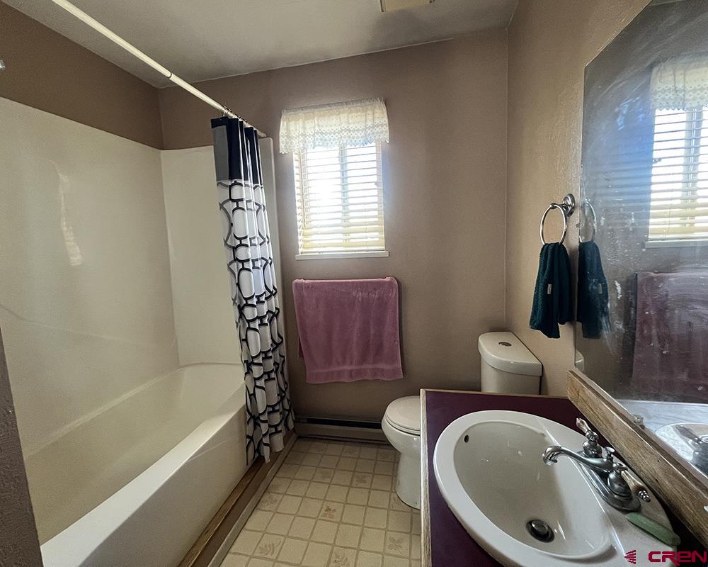 1328 Jackson Street Cortez, CO 81321 - Photo 20 of 37 a bathroom with a sink a toilet and bathtub