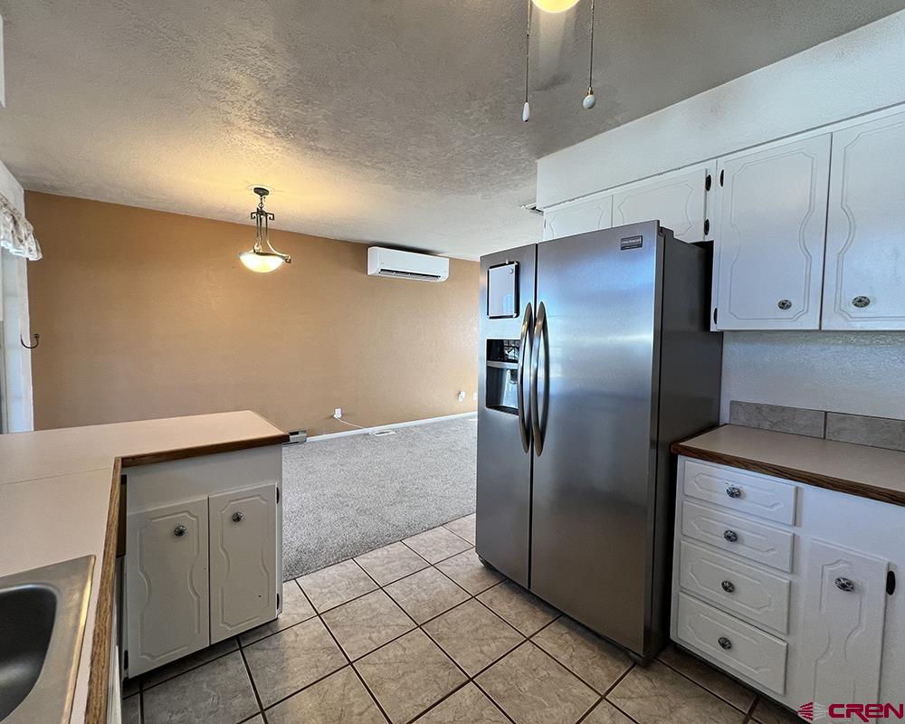 1328 Jackson Street Cortez, CO 81321 - Photo 21 of 45 a kitchen with stainless steel appliances granite countertop a refrigerator and a stove