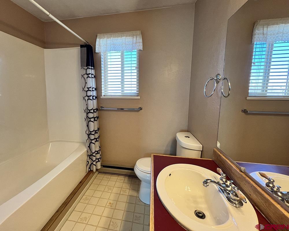 1328 Jackson Street Cortez, CO 81321 - Photo 24 of 45 a bathroom with a sink a bathtub and a shower