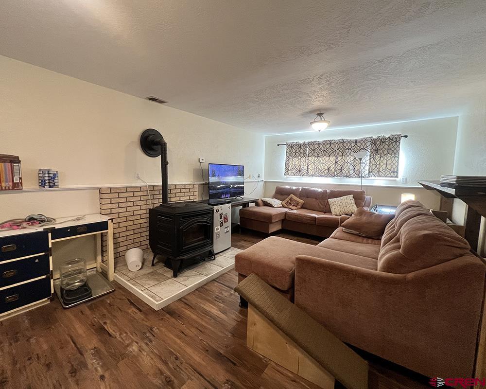 1328 Jackson Street Cortez, CO 81321 - Photo 8 of 37 a living room with furniture and a flat screen tv