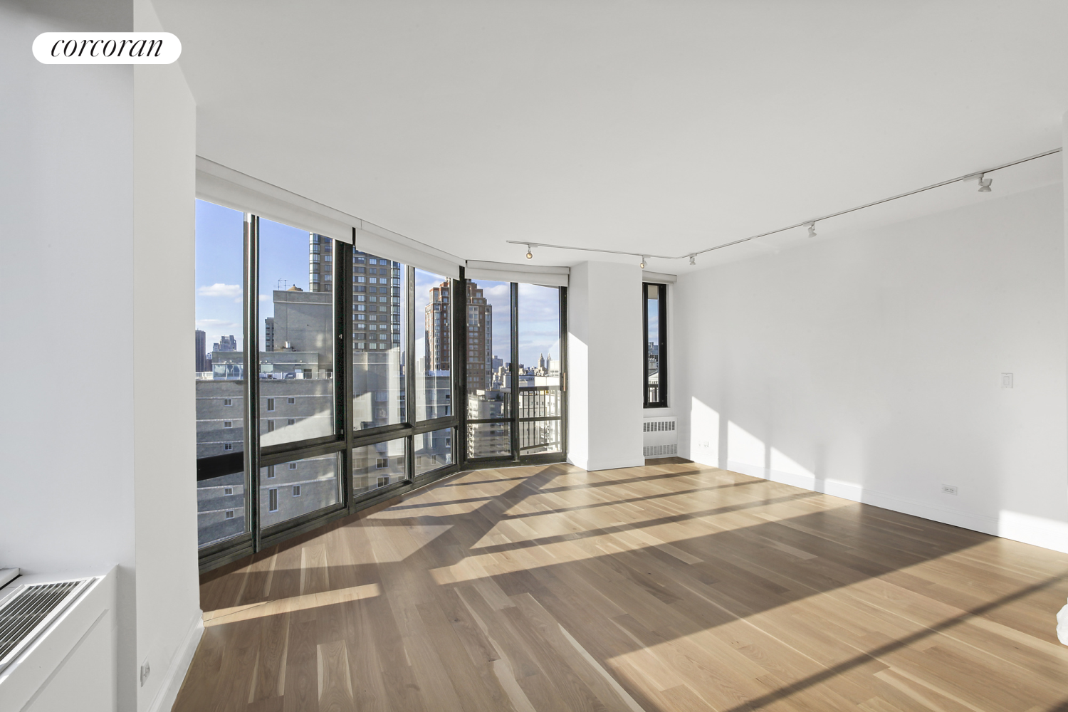 304 East 65th Street, Unit 26B Manhattan, NY 10065 - Photo 3 of 10 a bed sitting in a spacious bedroom next to a window