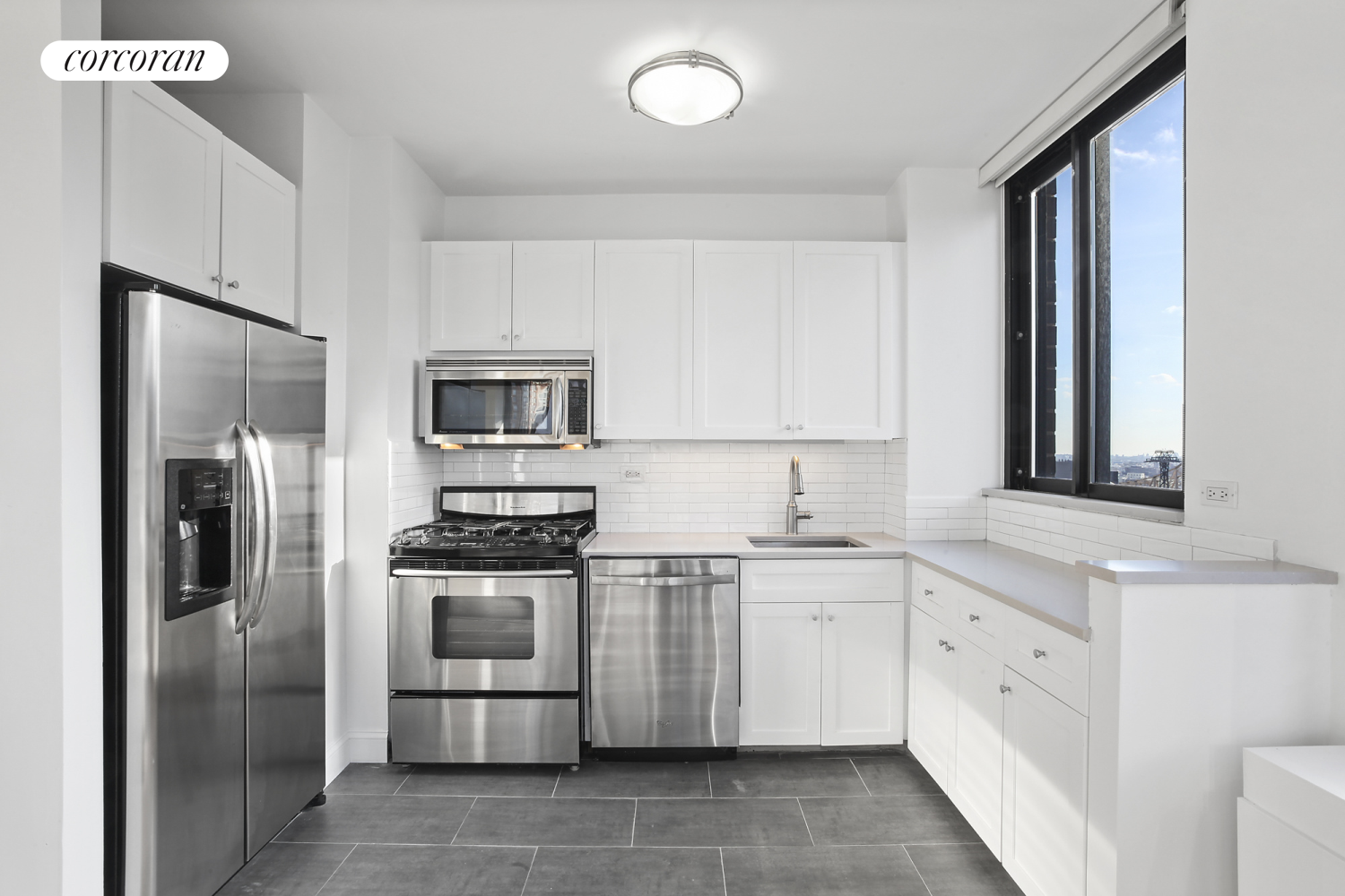 304 East 65th Street, Unit 26B Manhattan, NY 10065 - Photo 4 of 10 a kitchen with stainless steel appliances granite countertop a refrigerator sink and stove