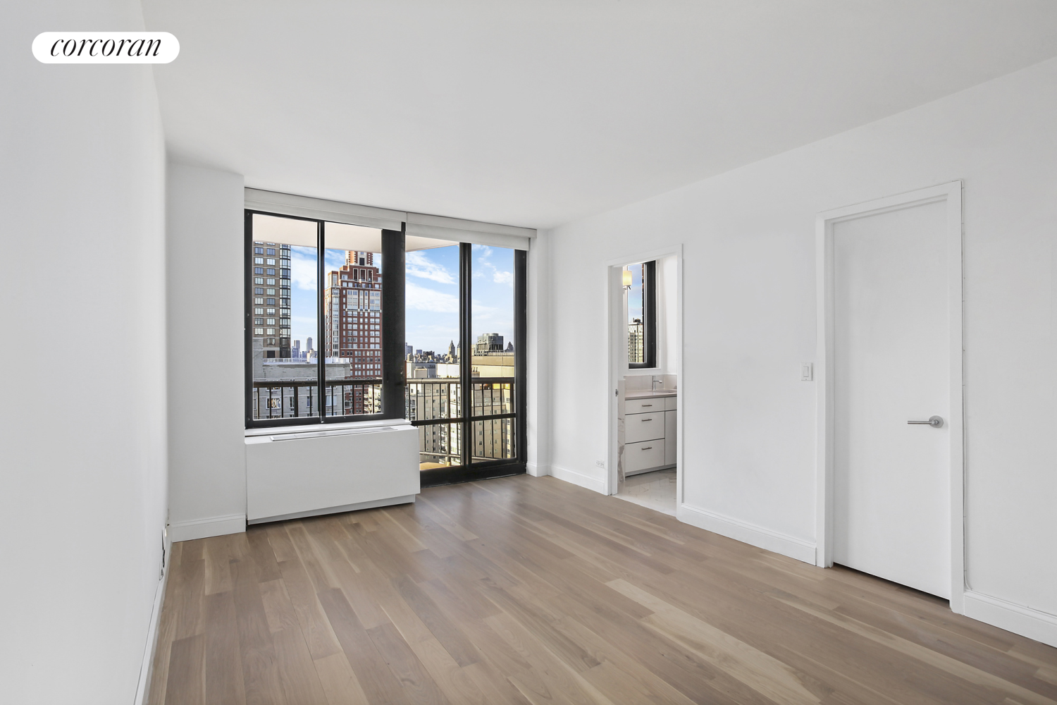 304 East 65th Street, Unit 26B Manhattan, NY 10065 - Photo 6 of 10 wooden floor in an empty room with a window