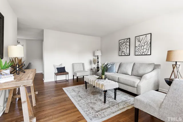 a living room with furniture and wooden floor