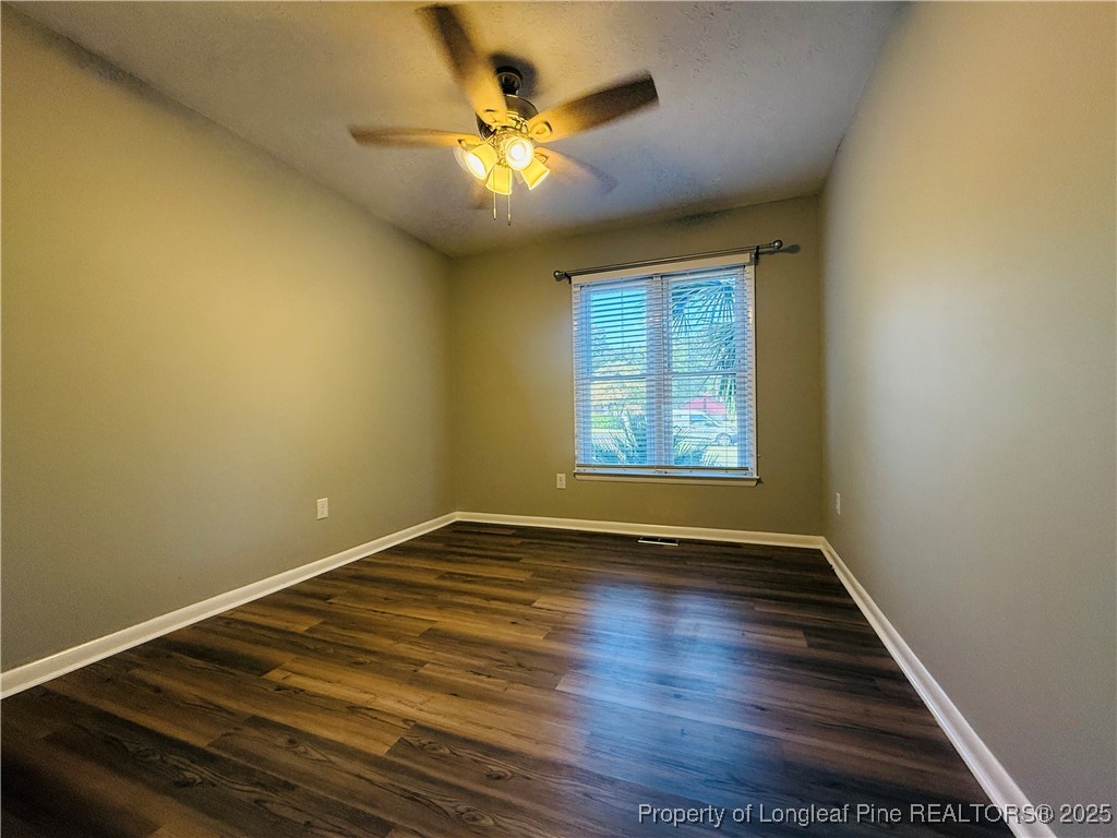 300 Wedge Court Hope Mills, NC 28348 - Photo 12 of 26 an empty room with wooden floor and windows