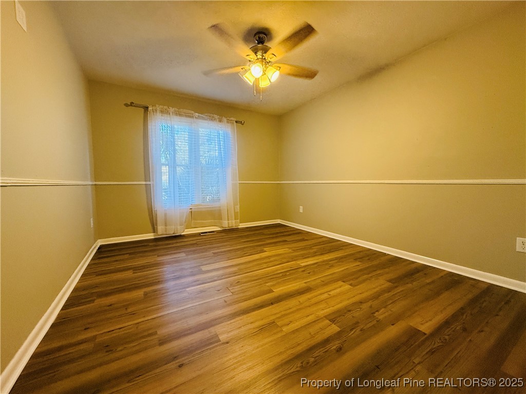 300 Wedge Court Hope Mills, NC 28348 - Photo 14 of 26 a view of a room with wooden floor and a ceiling fan