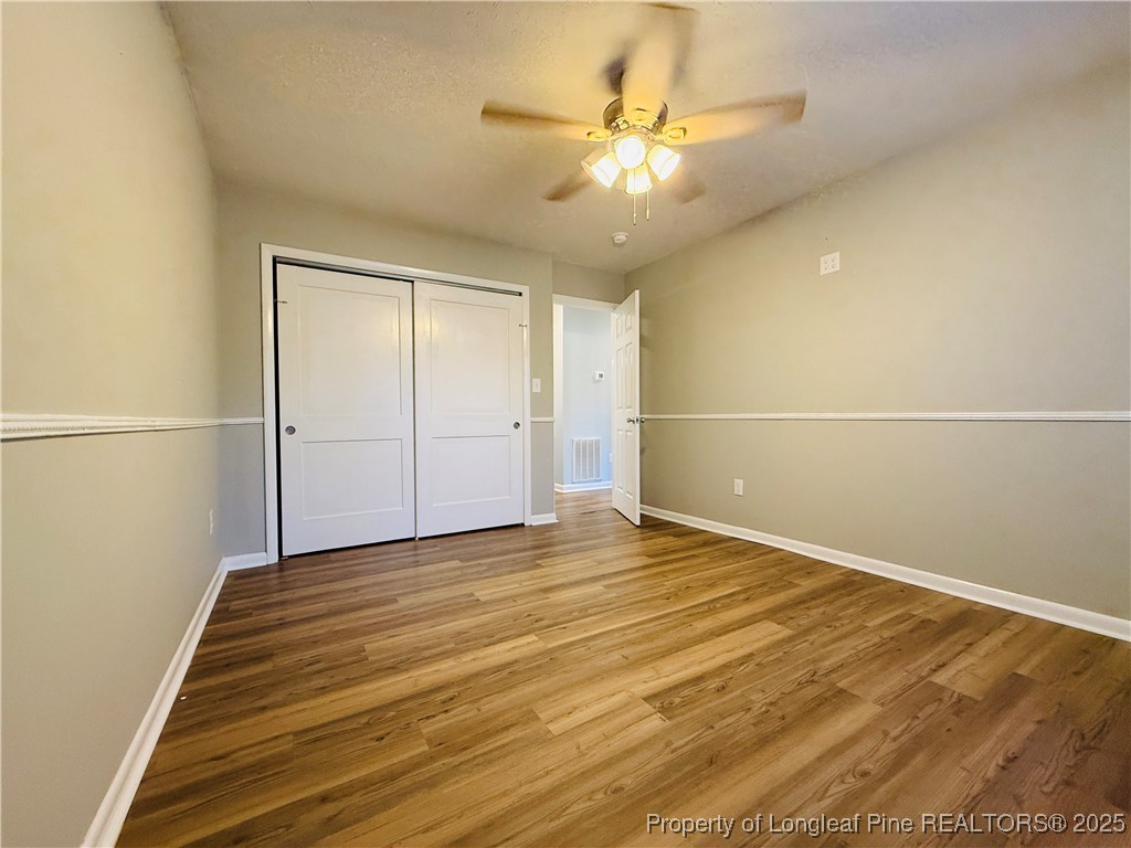 300 Wedge Court Hope Mills, NC 28348 - Photo 15 of 26 an empty room with wooden floor and fan