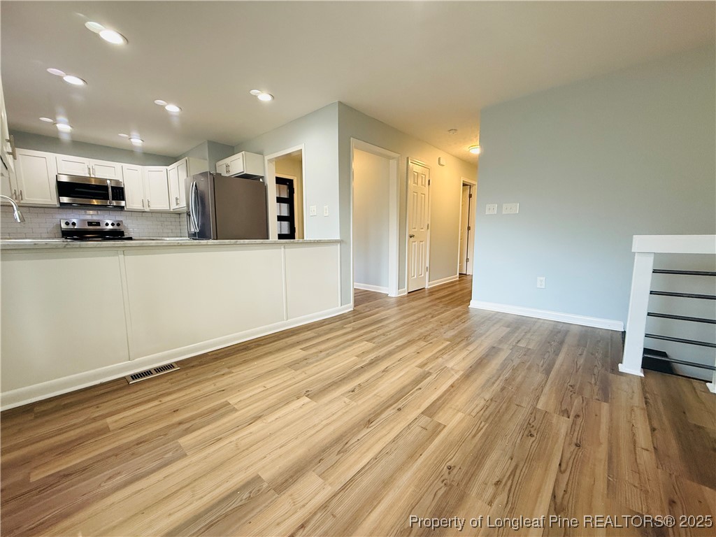 300 Wedge Court Hope Mills, NC 28348 - Photo 6 of 26 a view of room with wooden floor and windows