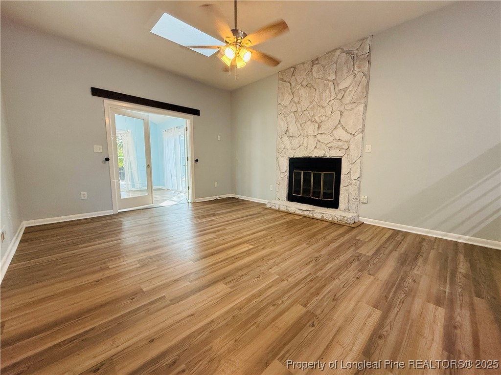 300 Wedge Court Hope Mills, NC 28348 - Photo 8 of 26 a view of an empty room with wooden floor fireplace and a window