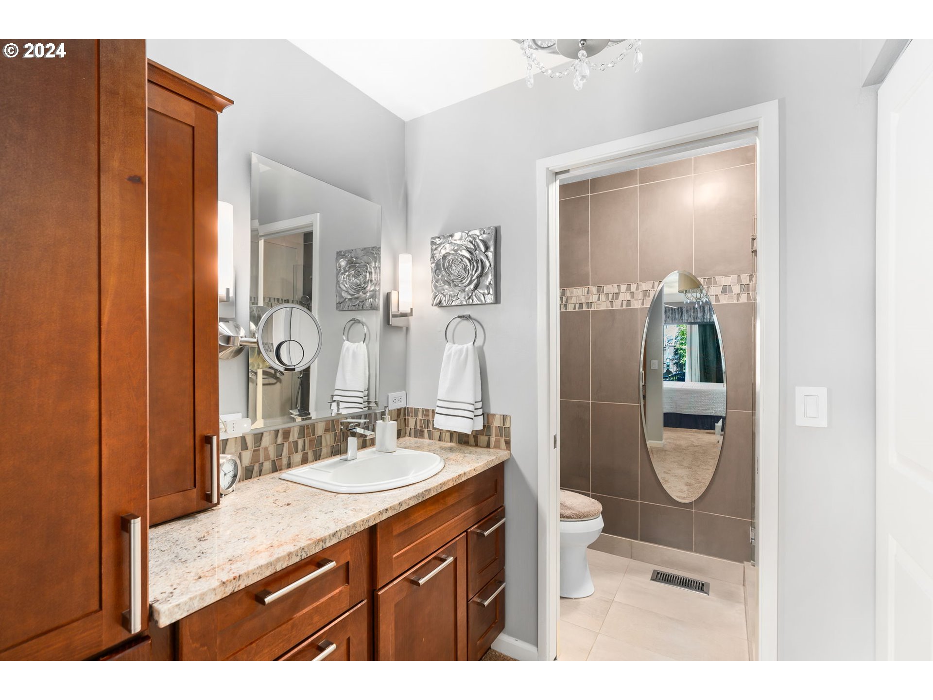 10 Condolea Drive Lake Oswego, OR 97035 - Photo 20 of 28 a bathroom with a granite countertop sink a toilet a mirror and shower