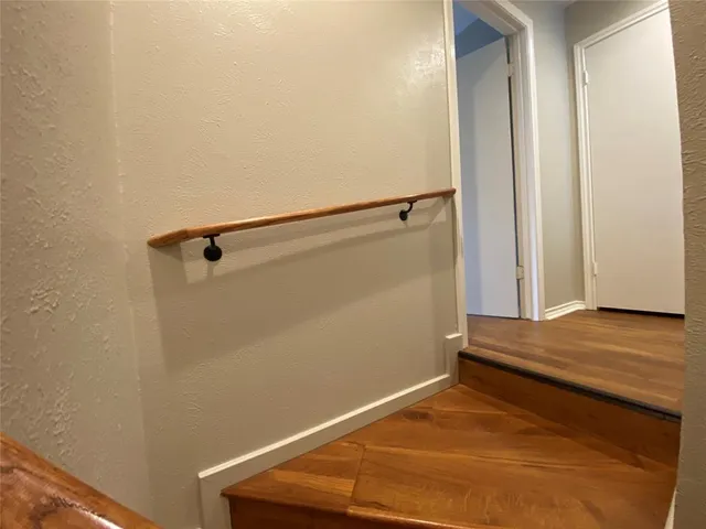 a view of a room with wooden floor