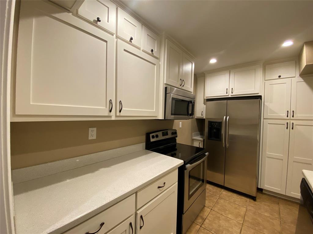 6 1 Main Place Benbrook, TX 76126 - Photo 8 of 28 a kitchen with stainless steel appliances a refrigerator sink and microwave