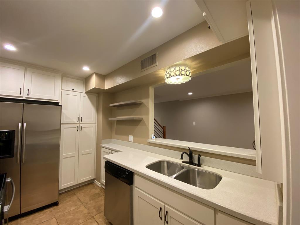 6 1 Main Place Benbrook, TX 76126 - Photo 9 of 28 a view of a kitchen with a sink and refrigerator
