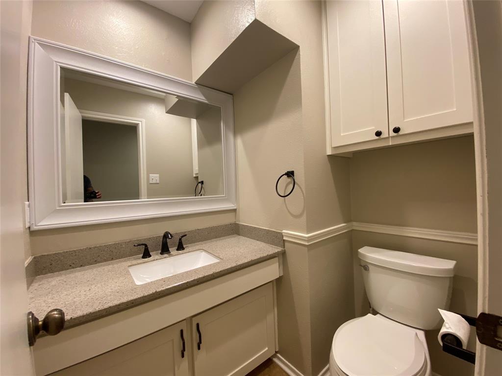 6 1 Main Place Benbrook, TX 76126 - Photo 10 of 28 a bathroom with a granite countertop toilet sink and mirror