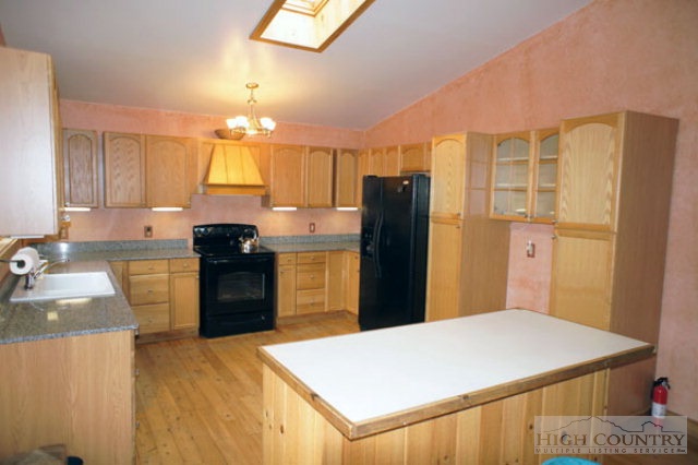 1994 Chestnut Grove Road Boone, NC 28607 - Photo 20 of 43 a kitchen with a refrigerator and a sink