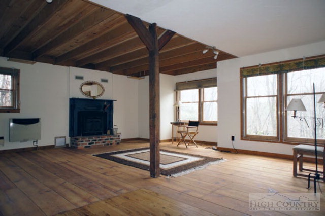 1994 Chestnut Grove Road Boone, NC 28607 - Photo 23 of 43 a living room with furniture a dining table and a large window