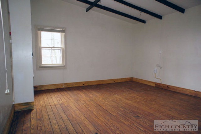 1994 Chestnut Grove Road Boone, NC 28607 - Photo 33 of 43 a view of an empty room with wooden floor and a window