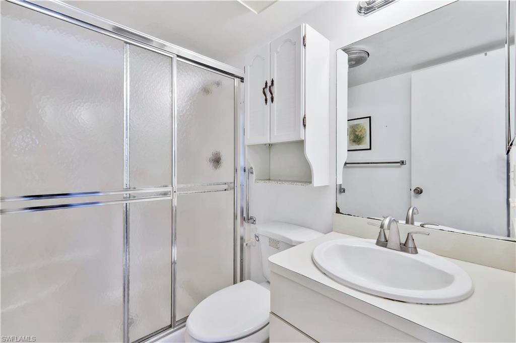 4357 27th Court Southwest, Unit 101 Naples, FL 34116 - Photo 15 of 25 a bathroom with a sink toilet and shower