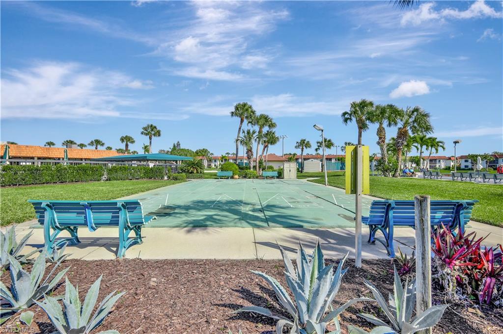 4357 27th Court Southwest, Unit 101 Naples, FL 34116 - Photo 23 of 25 a view of a swimming pool and outdoor seating