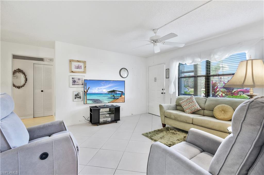 4357 27th Court Southwest, Unit 101 Naples, FL 34116 - Photo 5 of 25 a living room with furniture and a couch