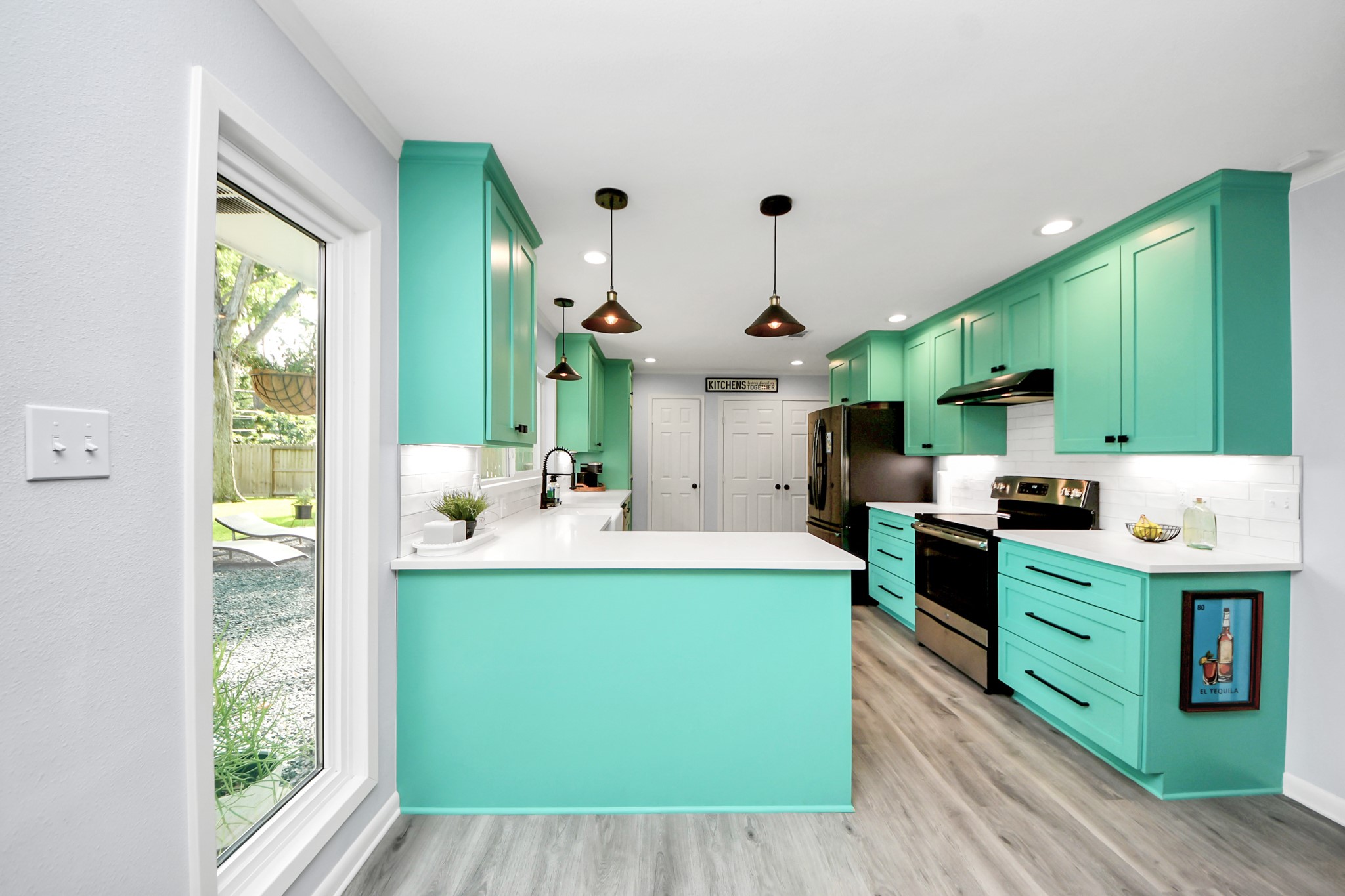 205 Cedar Lane El Lago, TX 77586 - Photo 9 of 44 a large kitchen with kitchen island a large counter top space a sink stainless steel appliances and cabinets