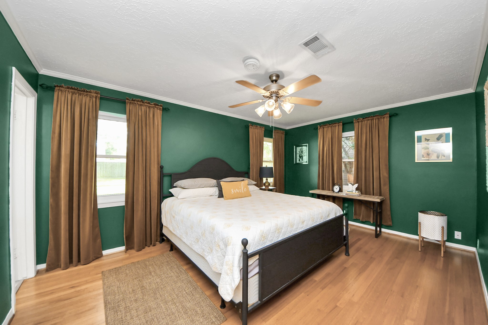 205 Cedar Lane El Lago, TX 77586 - Photo 21 of 44 a large bedroom with a large bed and a chandelier