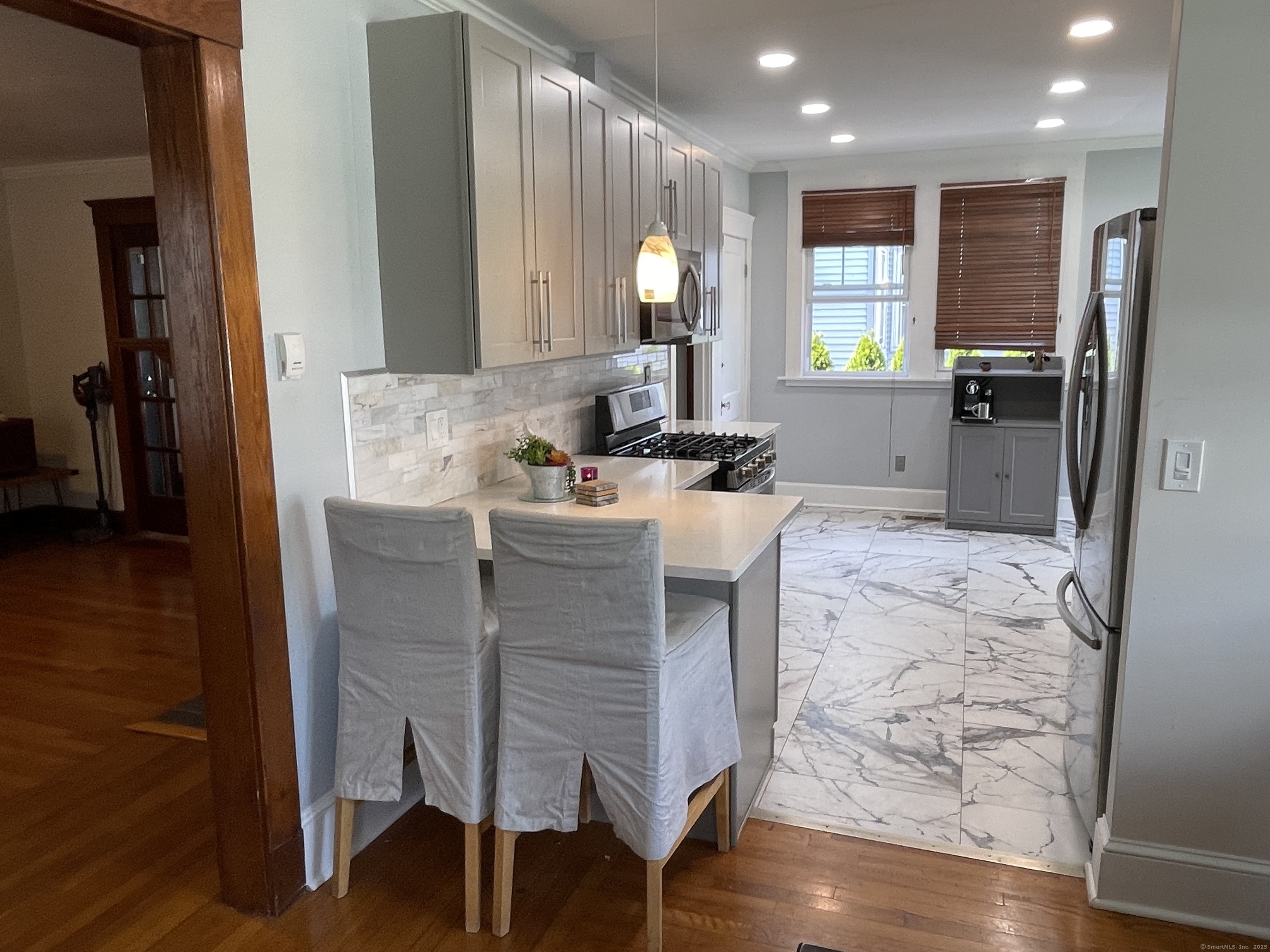 33 Mather Street Hamden, CT 06517 - Photo 12 of 22 a kitchen with a table chairs refrigerator and cabinets
