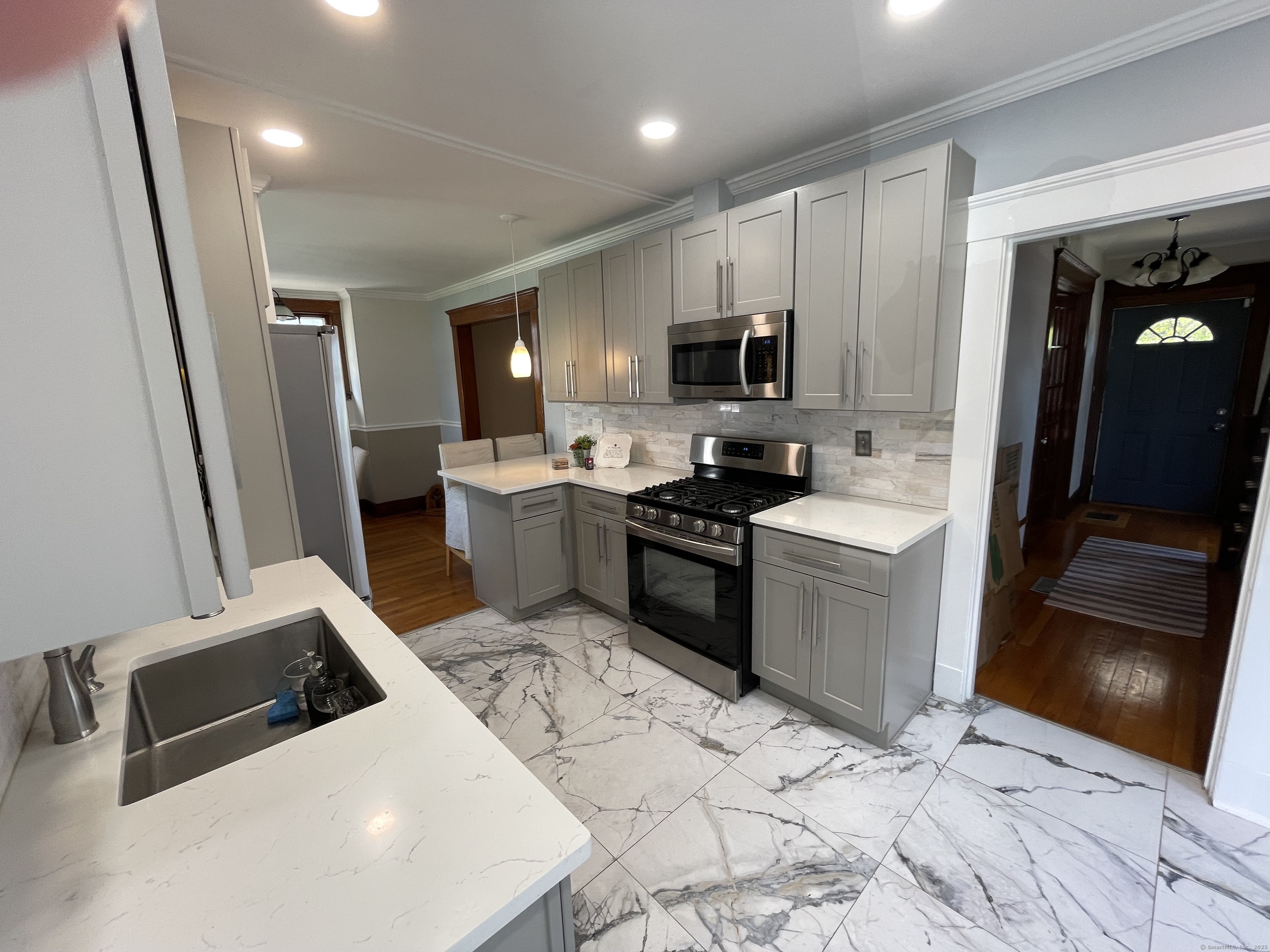 33 Mather Street Hamden, CT 06517 - Photo 15 of 22 a kitchen with stainless steel appliances a sink a stove a microwave a sink a refrigerator and cabinets