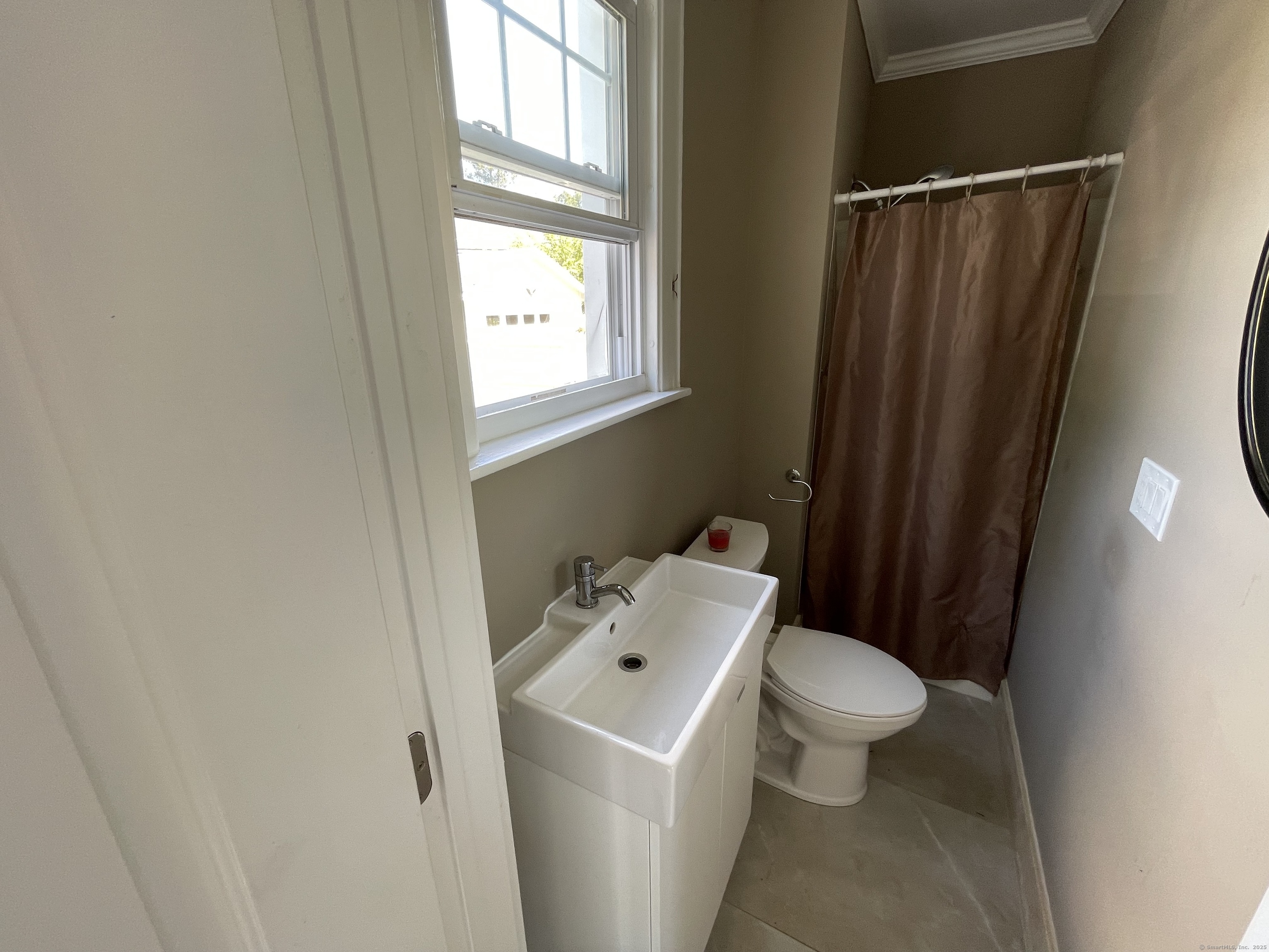 33 Mather Street Hamden, CT 06517 - Photo 16 of 22 a white toilet sitting next to a bathroom sink