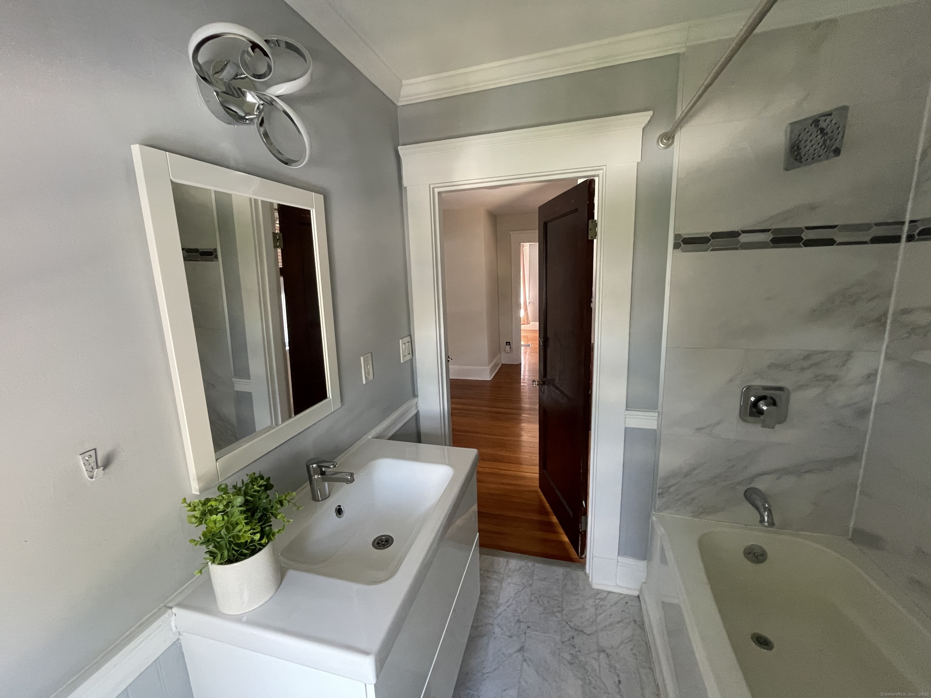 33 Mather Street Hamden, CT 06517 - Photo 17 of 22 a bathroom with a tub sink and mirror