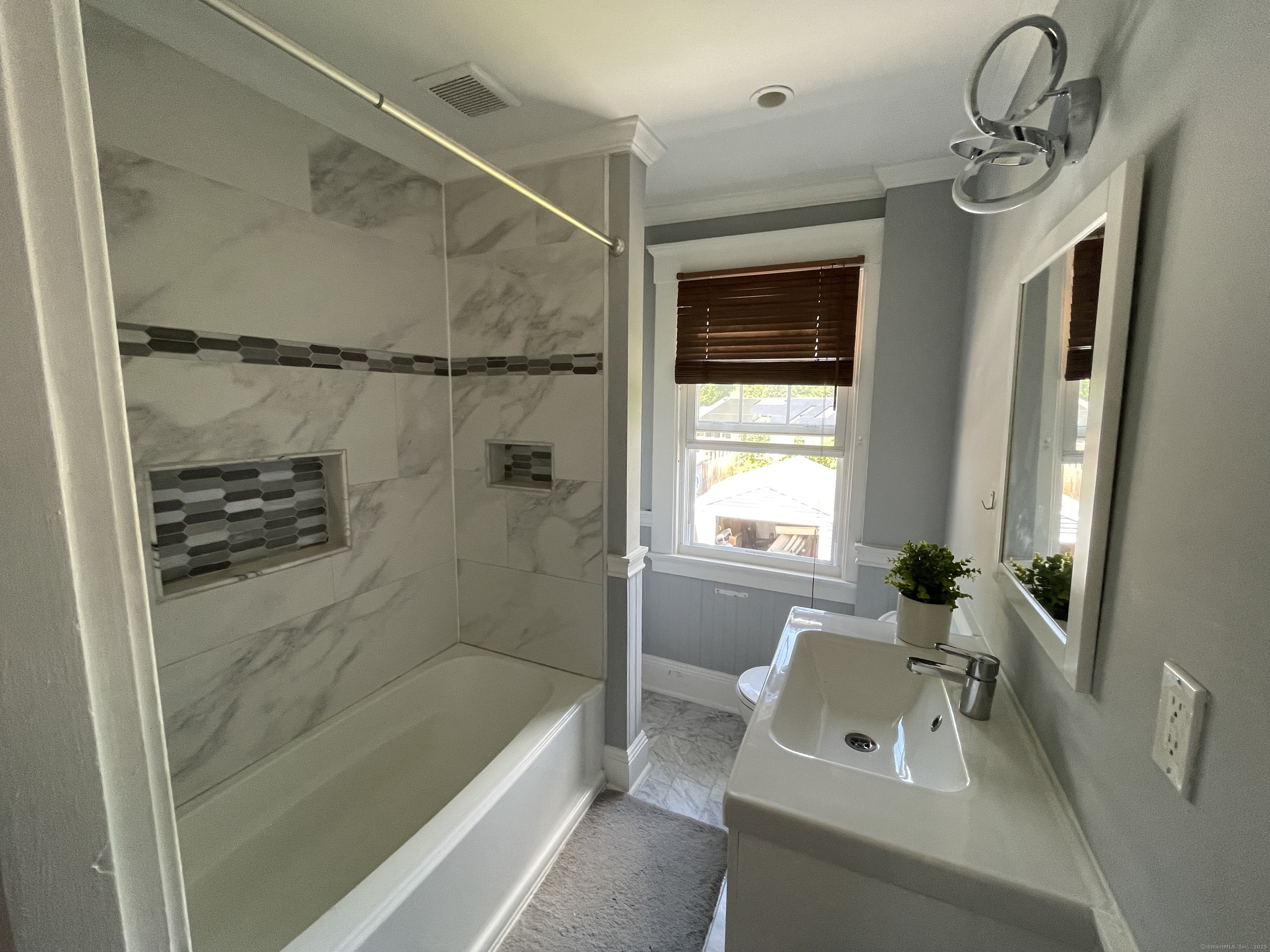 33 Mather Street Hamden, CT 06517 - Photo 18 of 22 a bathroom with a tub a sink and a large mirror