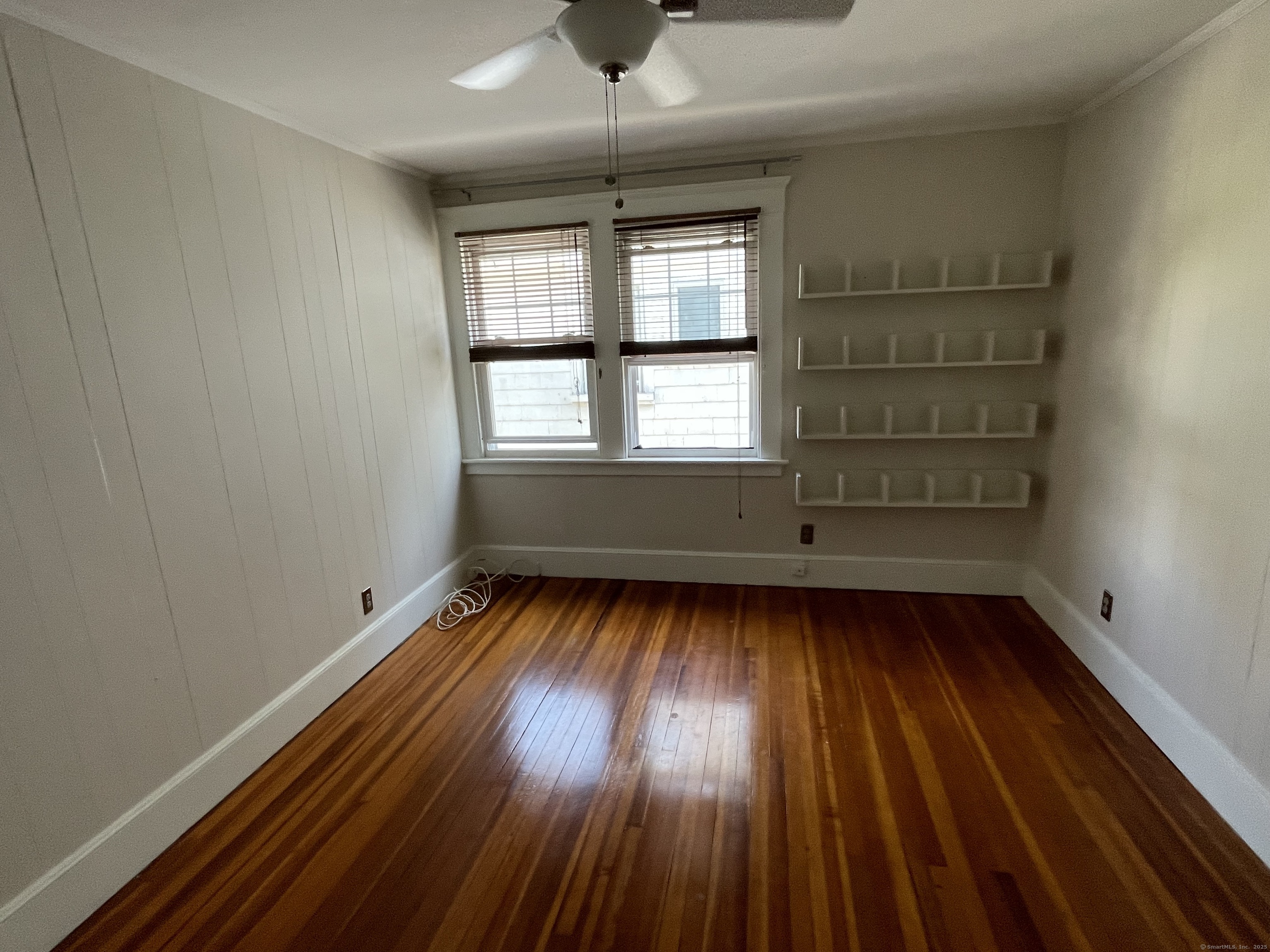 33 Mather Street Hamden, CT 06517 - Photo 20 of 22 an empty room with wooden floor and windows