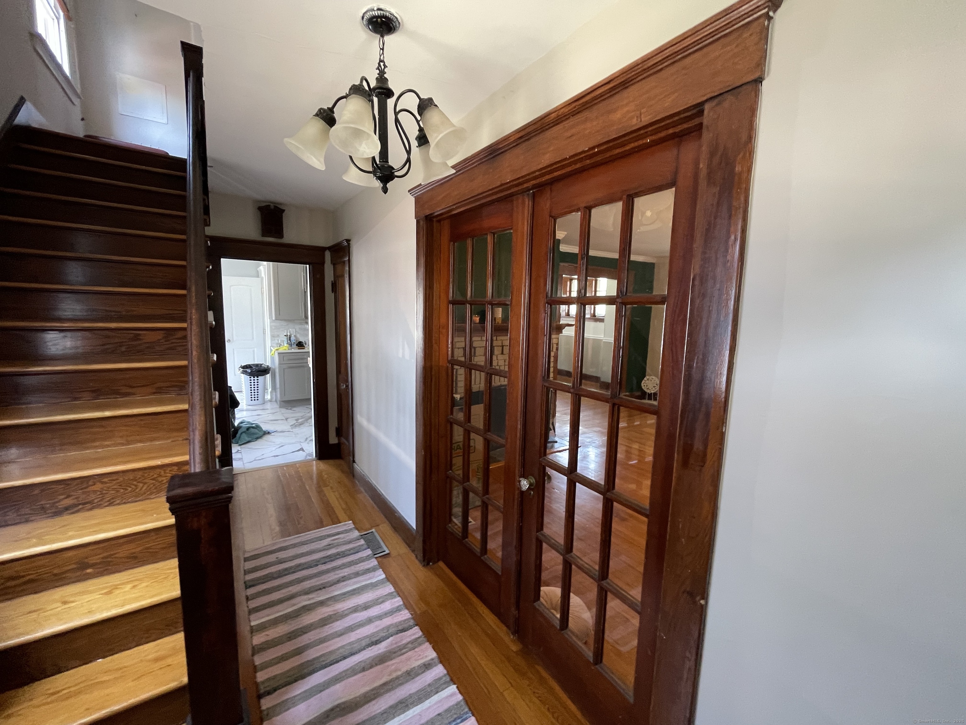 33 Mather Street Hamden, CT 06517 - Photo 5 of 22 a view of a hallway with wooden floor and stairs