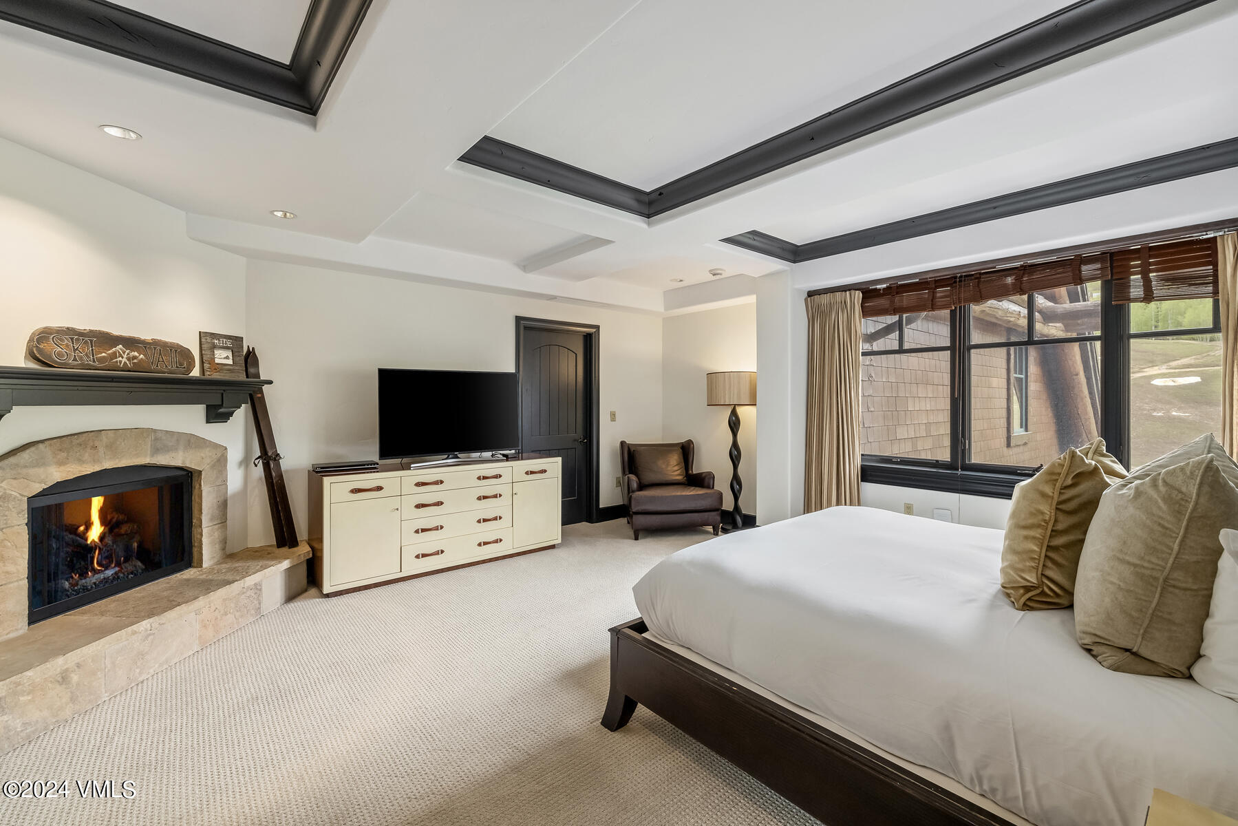 130 Daybreak Ridge Road, Unit R907 Avon, CO 81620 - Photo 19 of 49 a bedroom with a bed and a flat screen tv