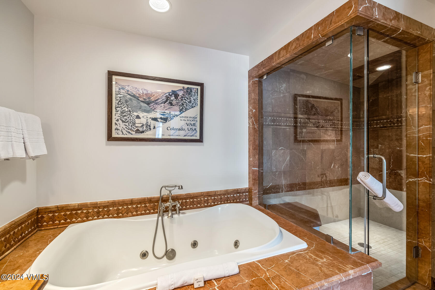 130 Daybreak Ridge Road, Unit R907 Avon, CO 81620 - Photo 22 of 49 a bathroom with a bathtub and a shower