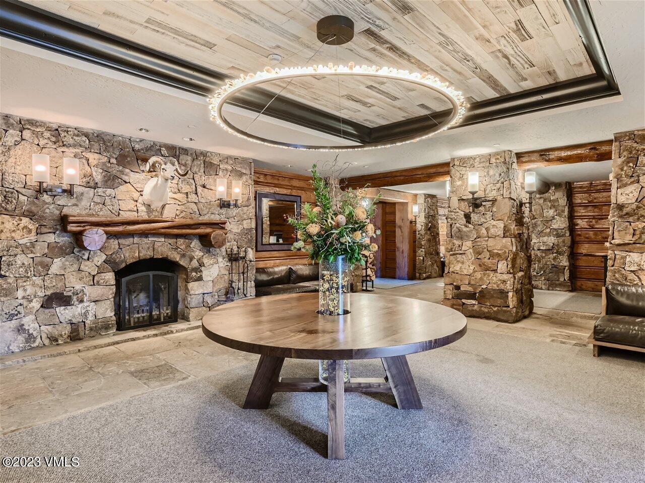 130 Daybreak Ridge Road, Unit R907 Avon, CO 81620 - Photo 34 of 49 a living room with furniture and a fireplace