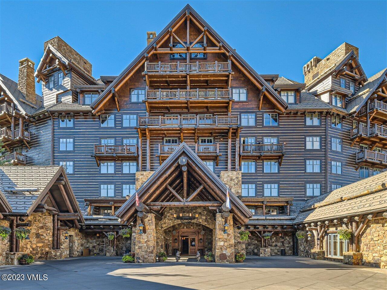 130 Daybreak Ridge Road, Unit R907 Avon, CO 81620 - Photo 42 of 49 a front view of a residential apartment building with a yard