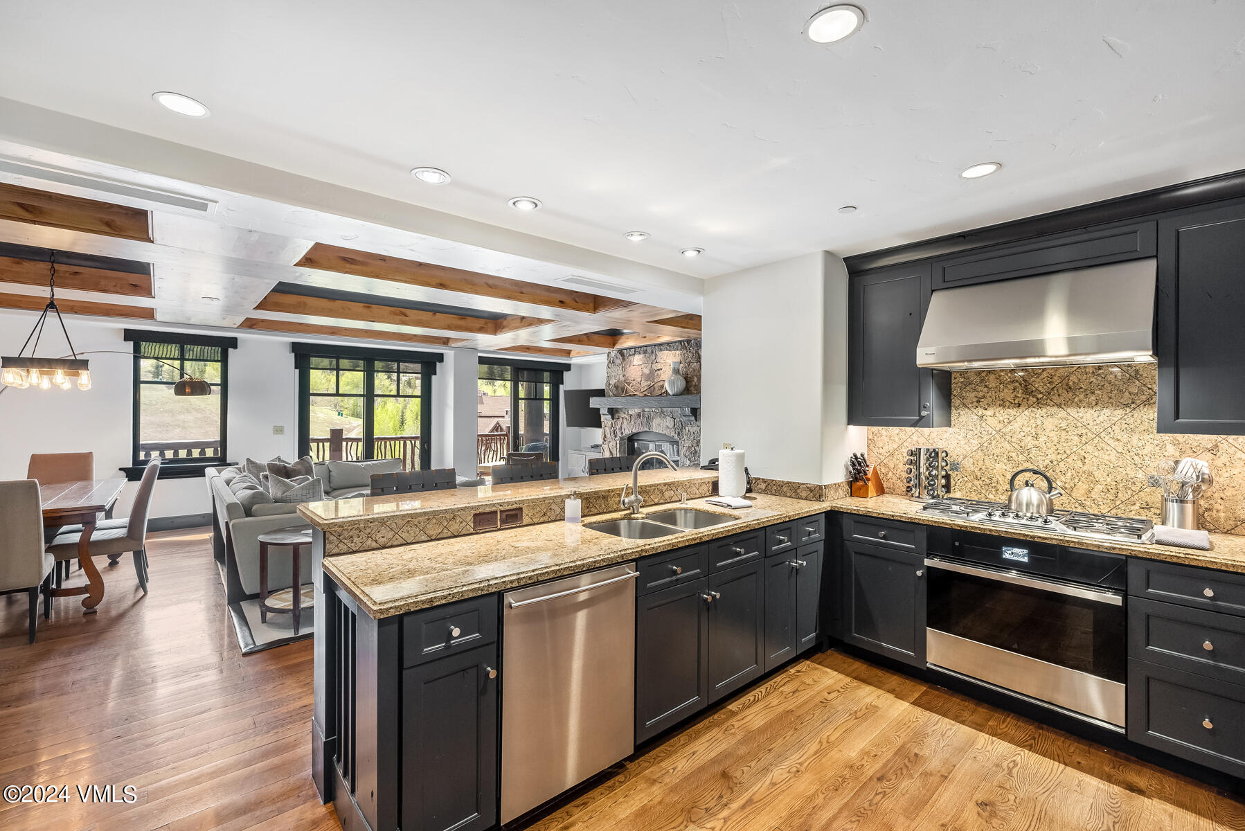 130 Daybreak Ridge Road, Unit R907 Avon, CO 81620 - Photo 8 of 49 a kitchen with a sink stove and cabinets