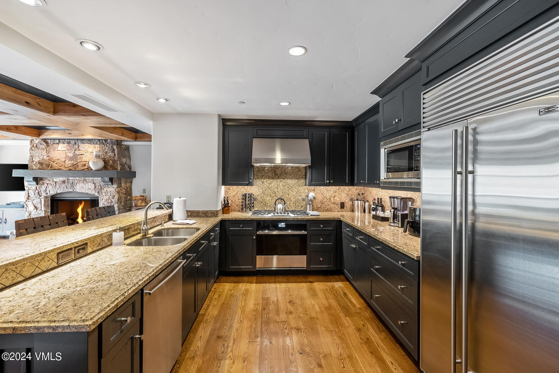 130 Daybreak Ridge Road, Unit R907 Avon, CO 81620 - Photo 9 of 49 a large kitchen with granite countertop lots of counter top space and stainless steel appliances