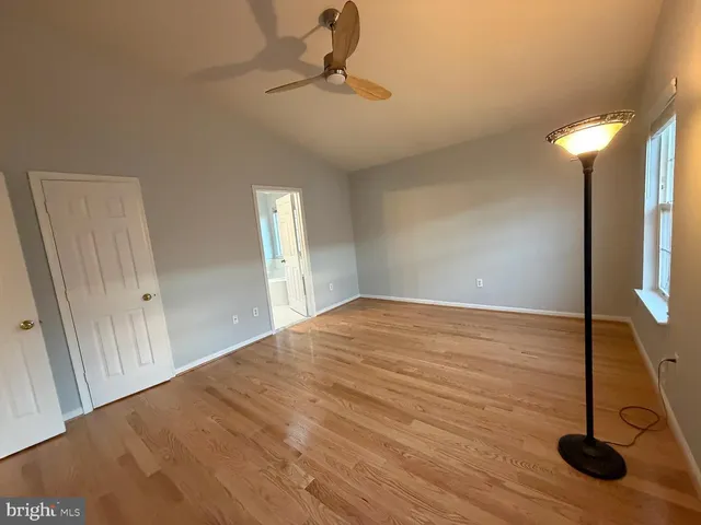 a view of a room with wooden floor and carpet
