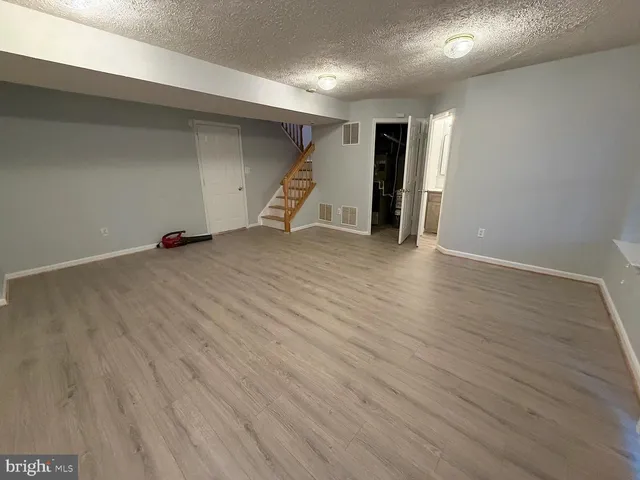 an empty room with wooden floor and closet