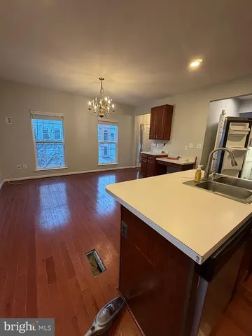 a view of livingroom with hardwood floor and kitchen view